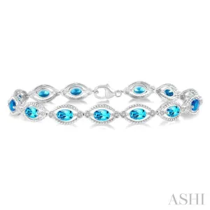 1/10 ctw Round Cut Diamond & 6x4MM Oval Cut Blue Topaz Semi Precious Bracelet in Sterling Silver